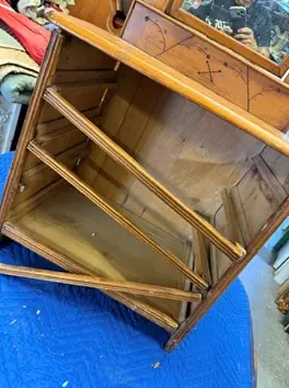 Before: the dresser frame and mirror apart on a blue tarp