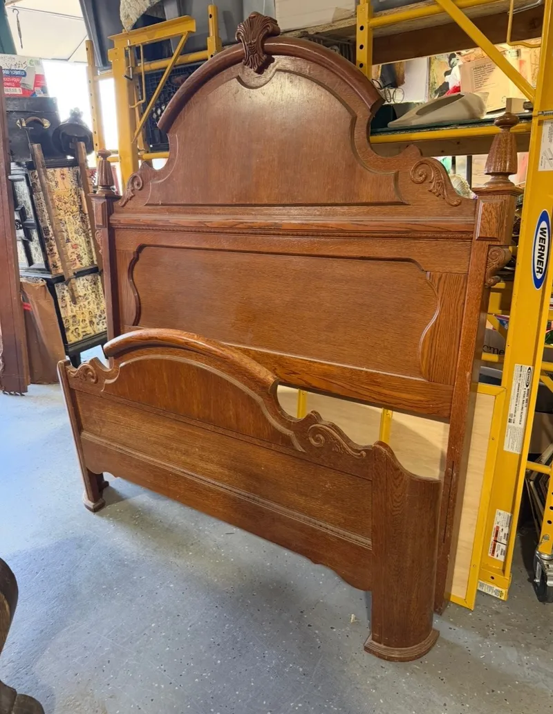 Before: a carved oak bed, headboard and footboard, as it came in