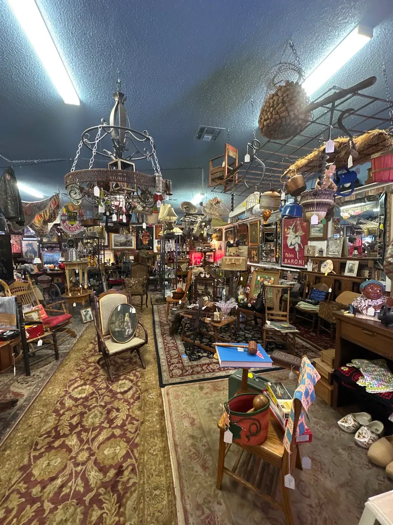 A long aisle of antiques under hanging chandeliers at Sample Studios in Apache Junction