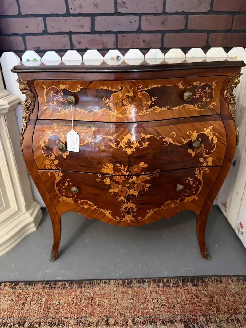 An inlaid bombe chest of drawers with floral marquetry at Sample Studios