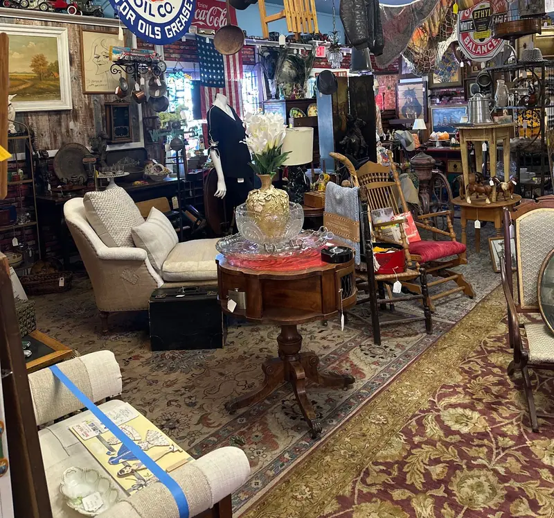 Armchairs, a round side table and patterned rugs on the floor at Sample Studios