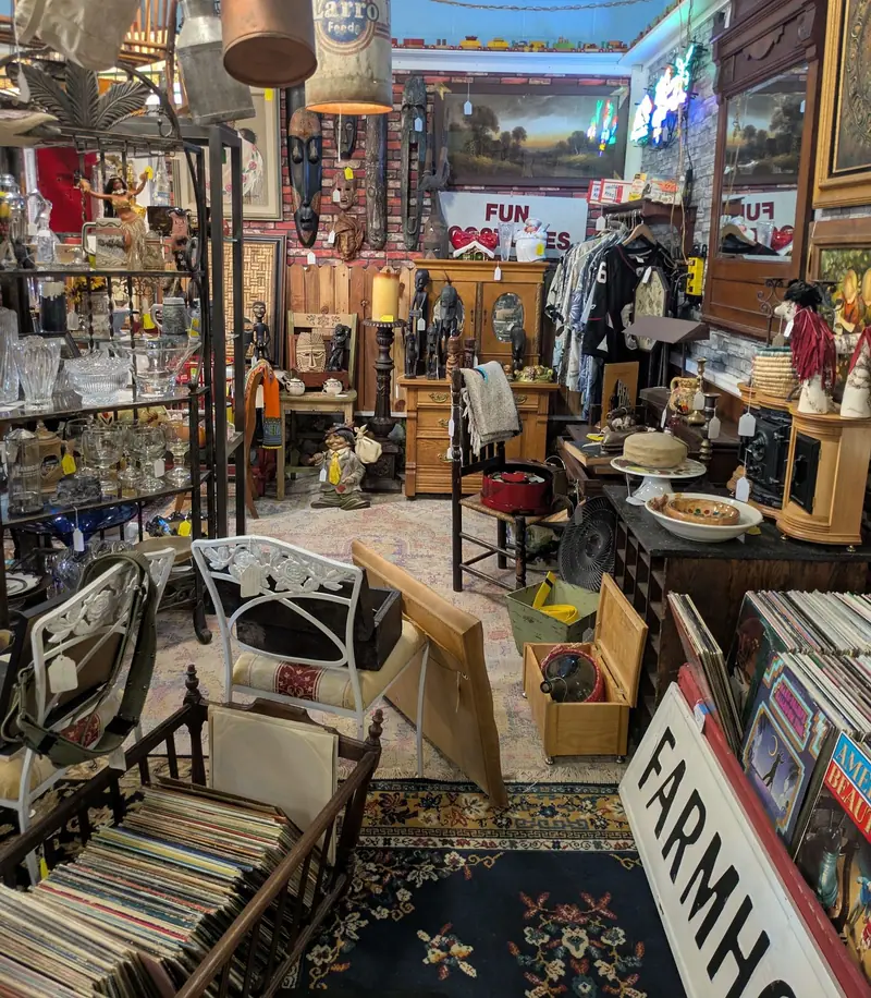 Record albums, glassware, chairs and antiques along an aisle at Sample Studios